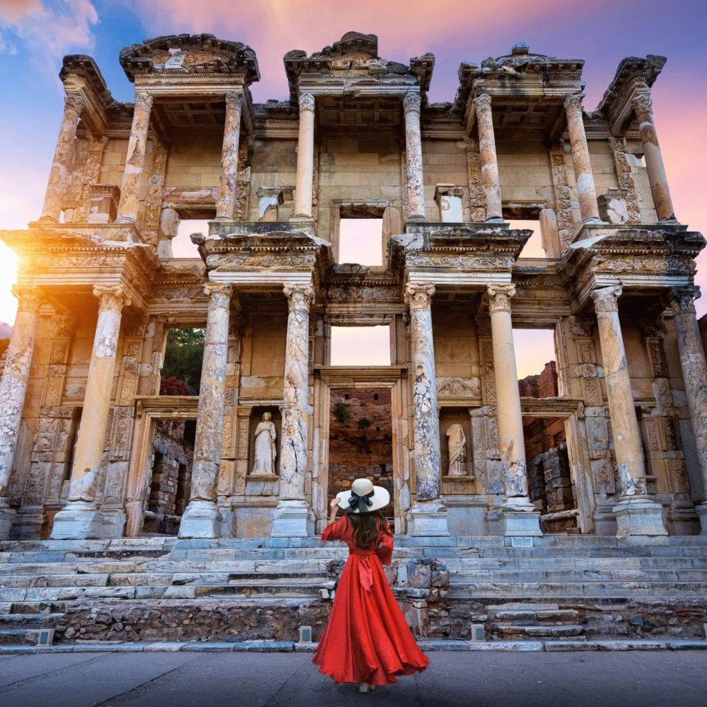 Woman in red dress at Celsus Library, Ephesus.