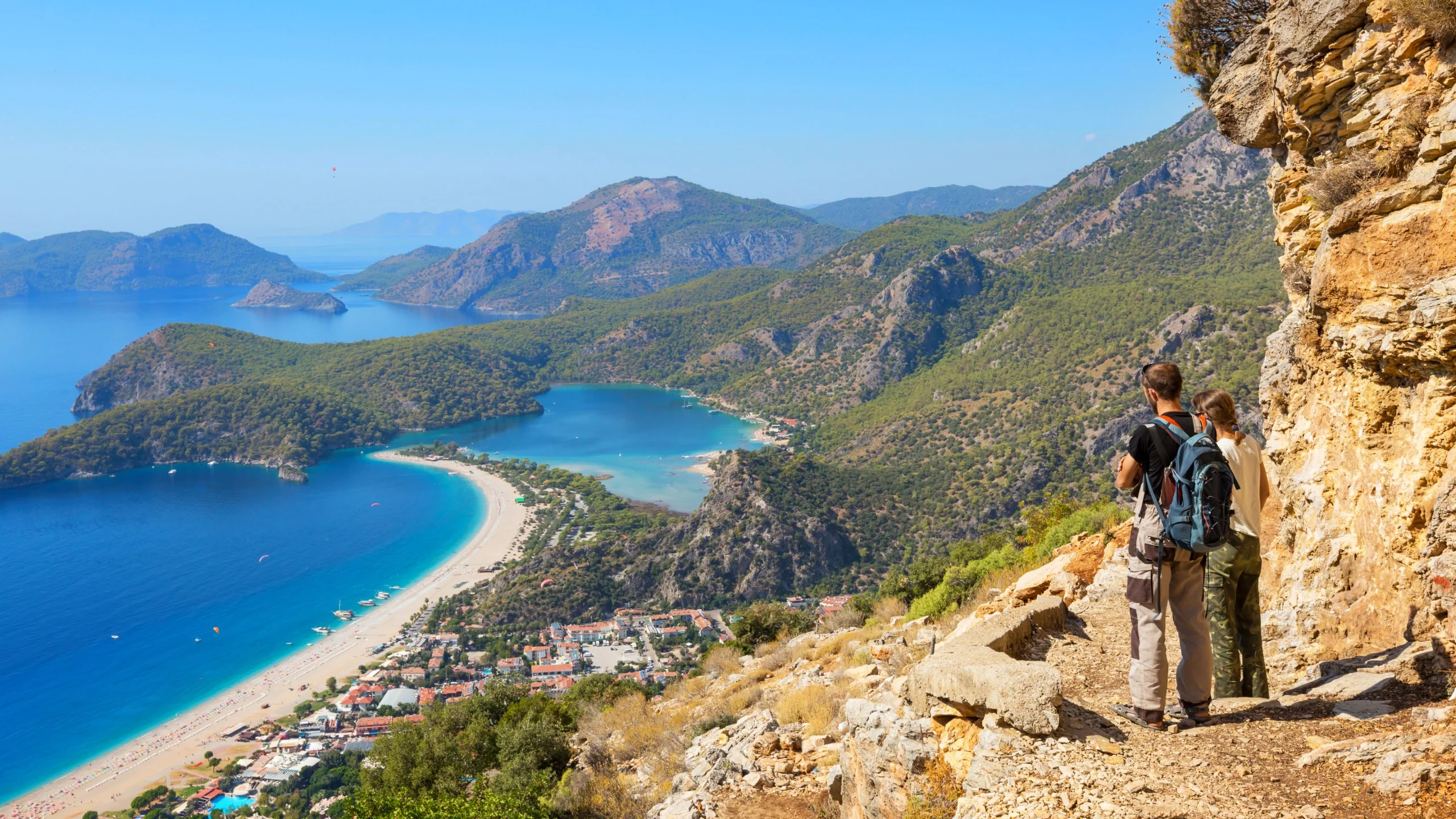 Scenic view of Turkish coastline with mountains and blue sea.