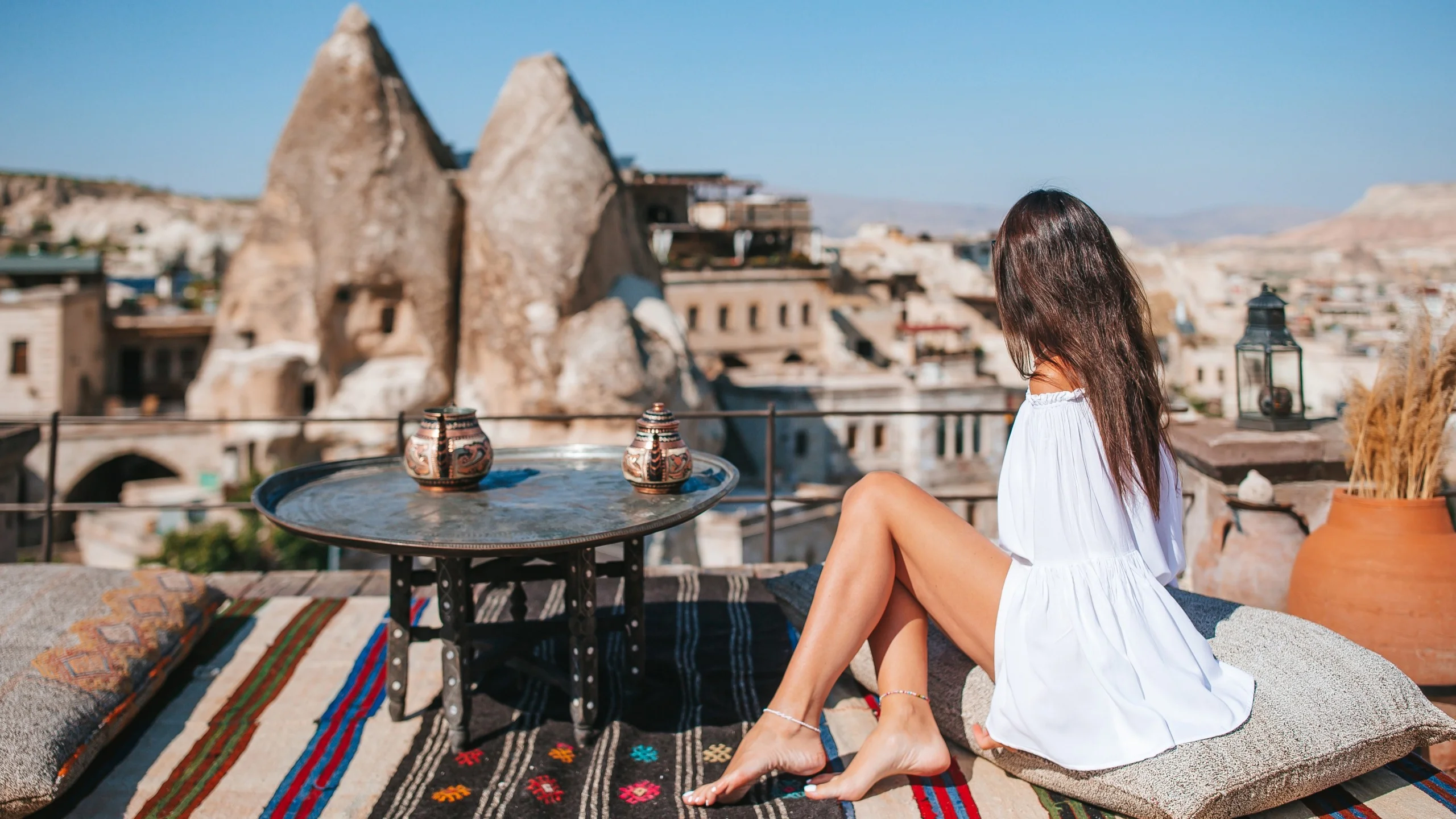 Woman enjoying sunrise view in Cappadocia, Turkey